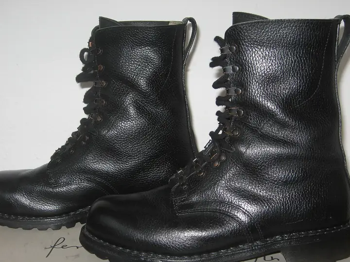 A pair of black leather lace-up duty boots with lug soles