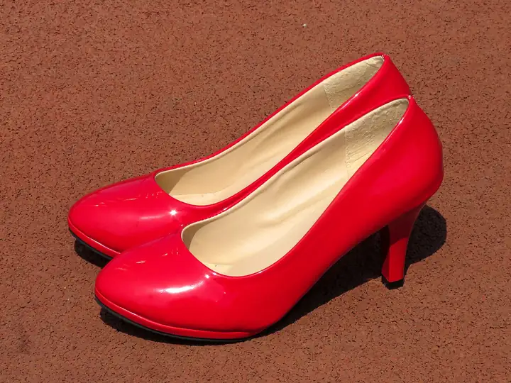 A pair of red patent high-heeled pumps